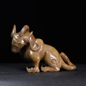 A Chinese Carved Jade Foo-Dog Statuette