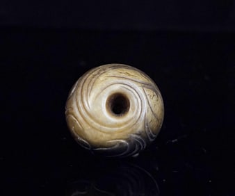 A Chinese Carved Jade Bead