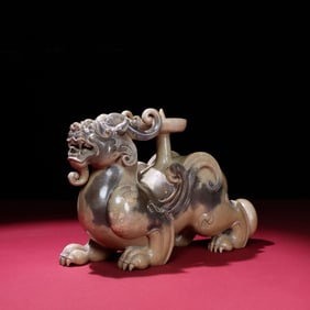 A Chinese Carved Jade Foo-Dog Statuette