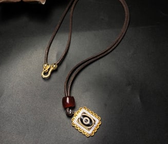 A Chinese Carved Agate DZI Bead with Silver Inlaid Necklace