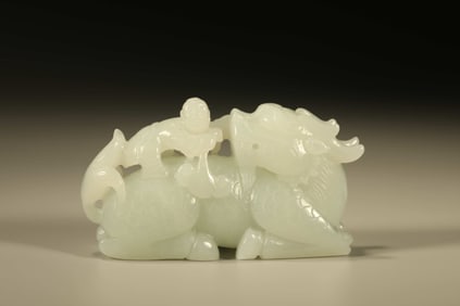 A Chinese Carved Jade Foo-Dog and Boy Statuette