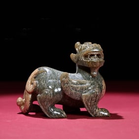 A Chinese Carved Jade Foo-Dog Statuette