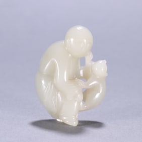 A Chinese Carved Jade Boy and Foo-Dog Statuette