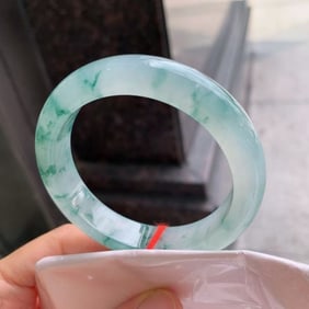 A Chinese Carved Jadeite Bangle
