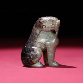 A Chinese Carved Jade Foo-Dog Statuette