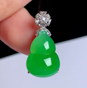 A Chinese Carved Jadeite Double Gourd Pendant