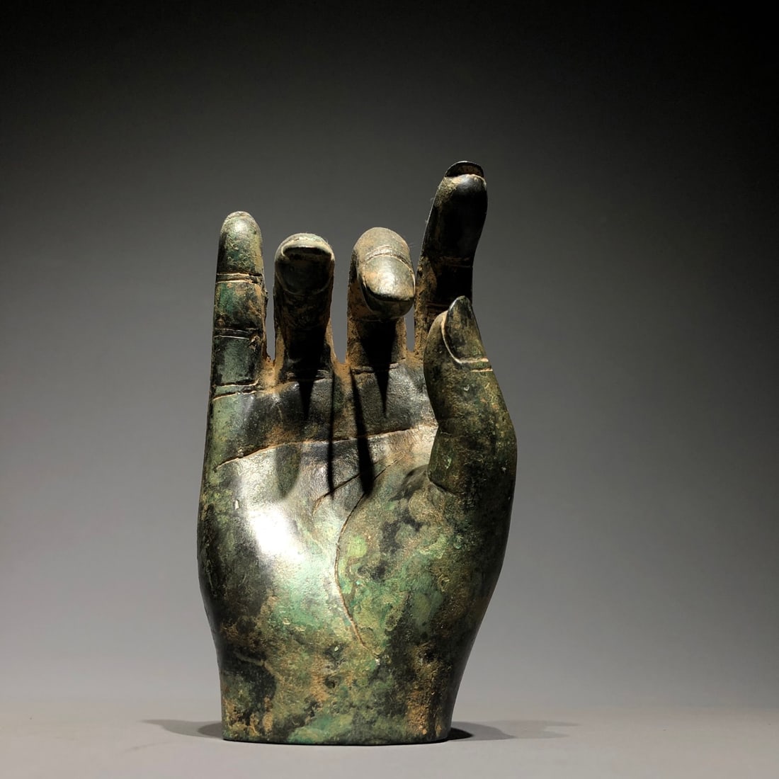 A Chinese Bronze Buddha Hand Statuette: Diam. 13cm, Wd. 6.5 cm, Wt. 600g