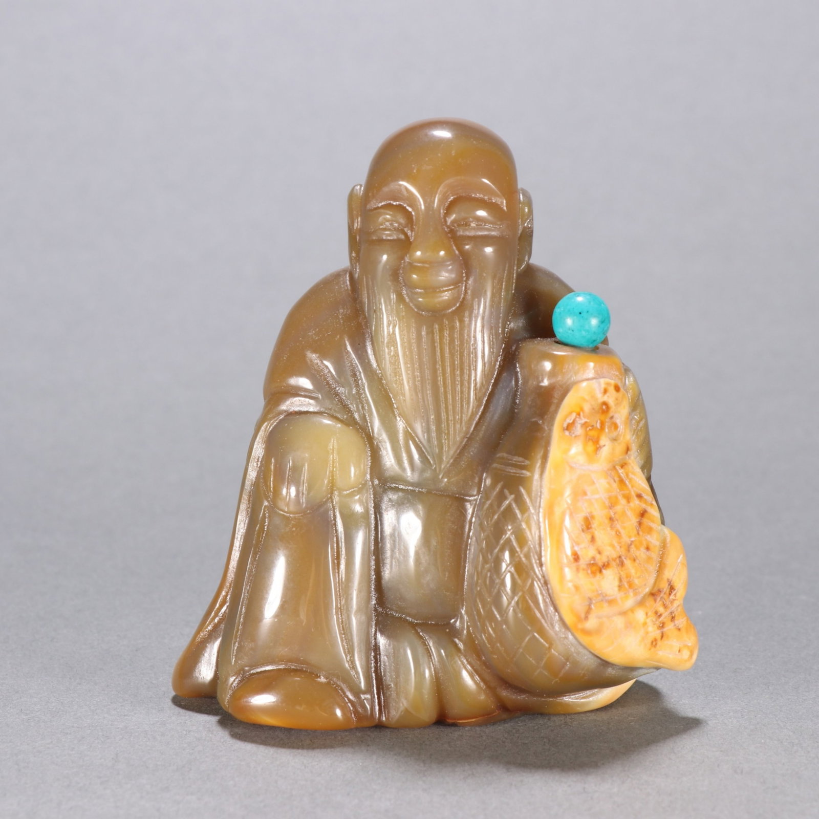 A Chinese Carved Agate Figure of Fisherman Snuff Bottle: Ht. 8.7cm, Wd. 7.8cm, Wt. 254.8g