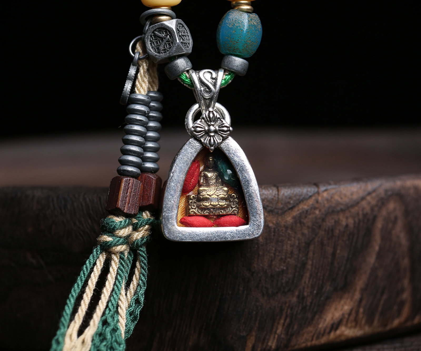 A Chinese Silver and Gilt Bronze Figure of Buddha Necklace: Ht. 2.1cm, Wd. 1.9cm, Th. 1cm, Wt. 42g