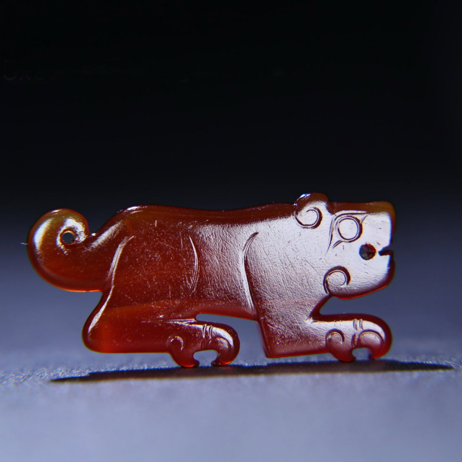 A Chinese Carved Jade Tiger Pendant: Lg. 5.5cm, Wd. 2.5cm, Th. 0.6cm, Wt. 14g