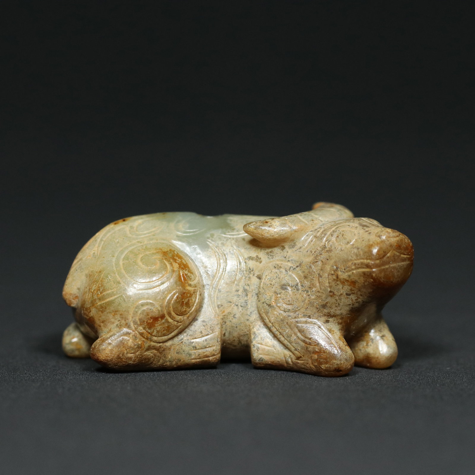 A Chinese Carved Jade Bull Statuette: Lg. 5.8cm, Wd. 2.7cm, Th. 2.4cm, Wt. 58.5g