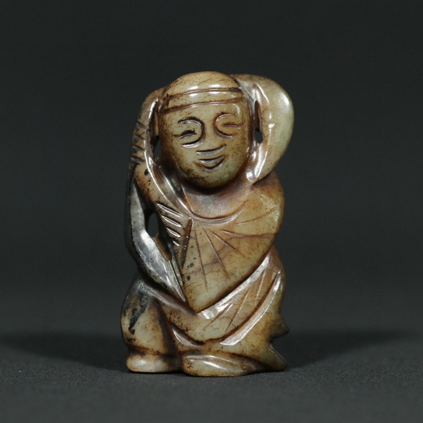 A Chinese Carved Jade Figure of Boy: Lg. 5.5cm, Wd. 3.1cm, Th. 1.7cm, Wt. 40.7g