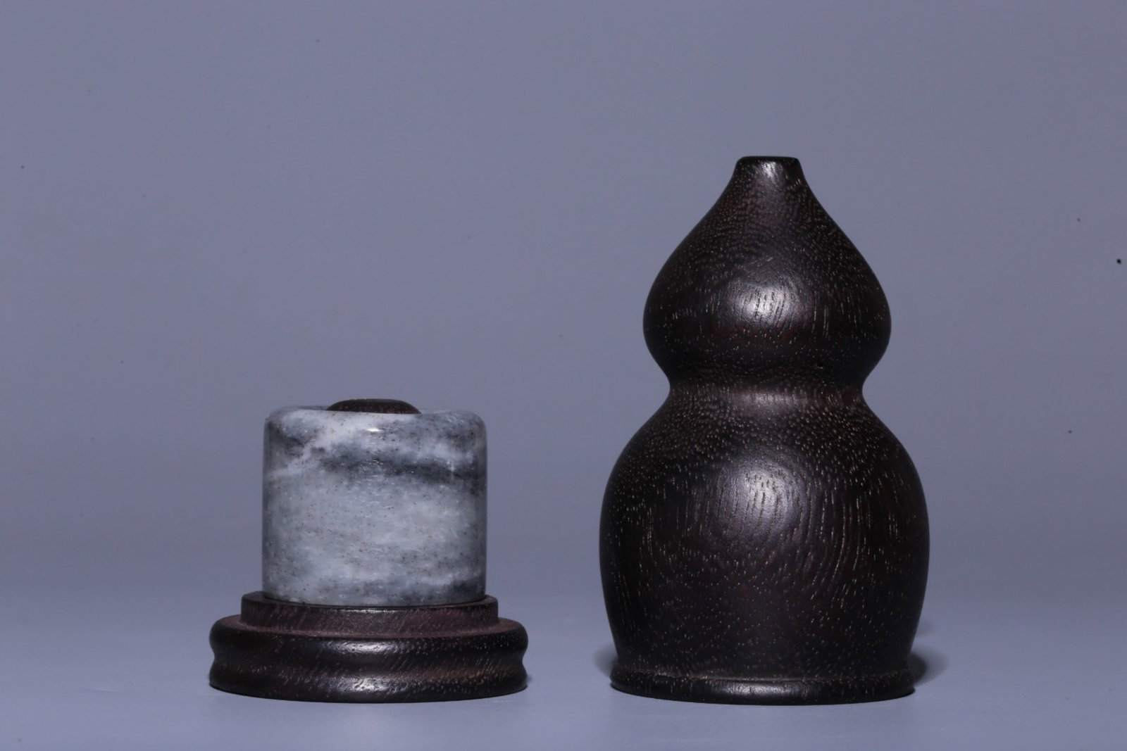 A Chinese Carved Jade Ring with Hardwood Double-Gourd Case: Ht. 3cm?Diam. 3.5cm, Diam. 2.1cm, Wt. 46g