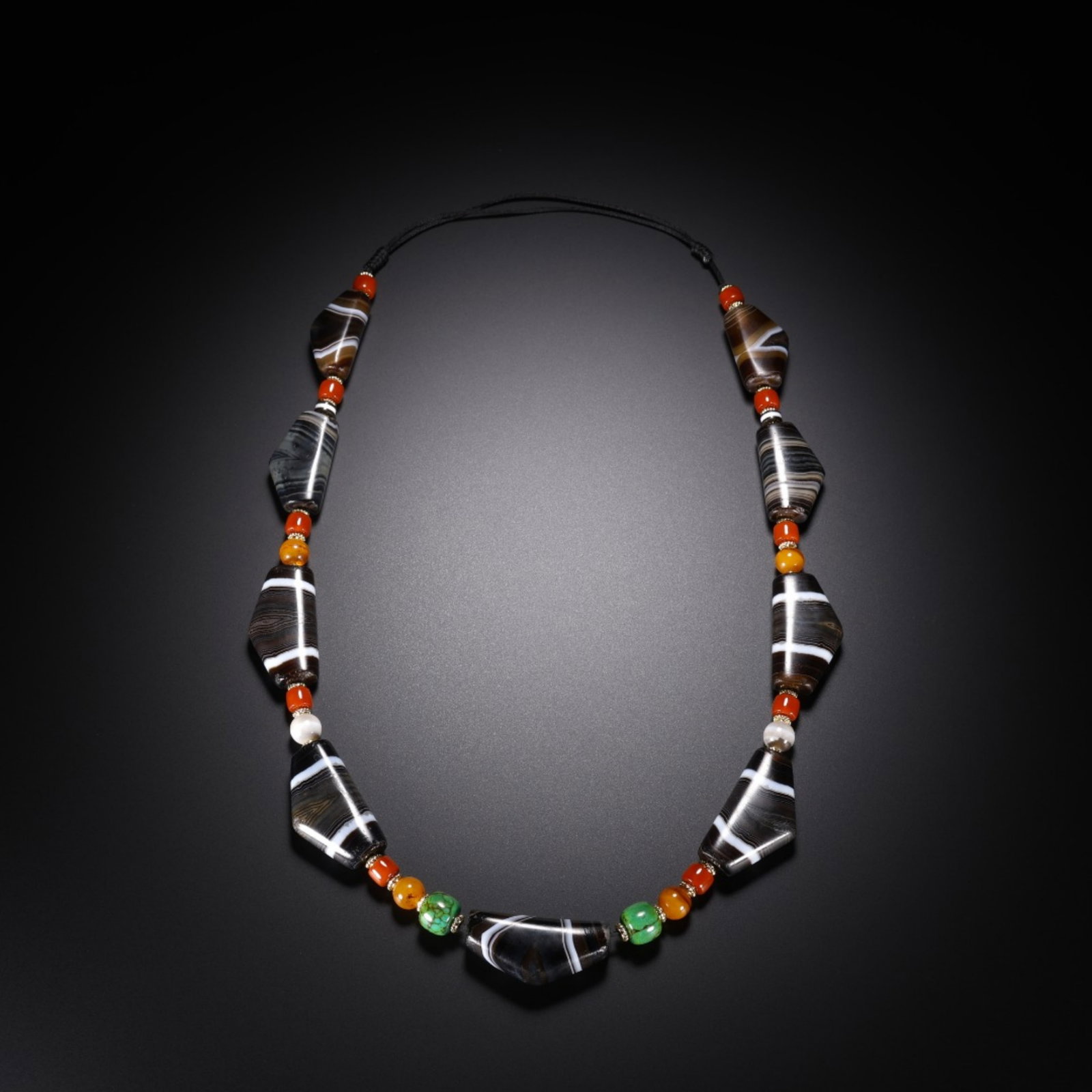 A Chinese Carved Agate DZI Beads Necklace: The Beads, Lg. 3.5cm, Wd. 1.3cm, Wt. 103g