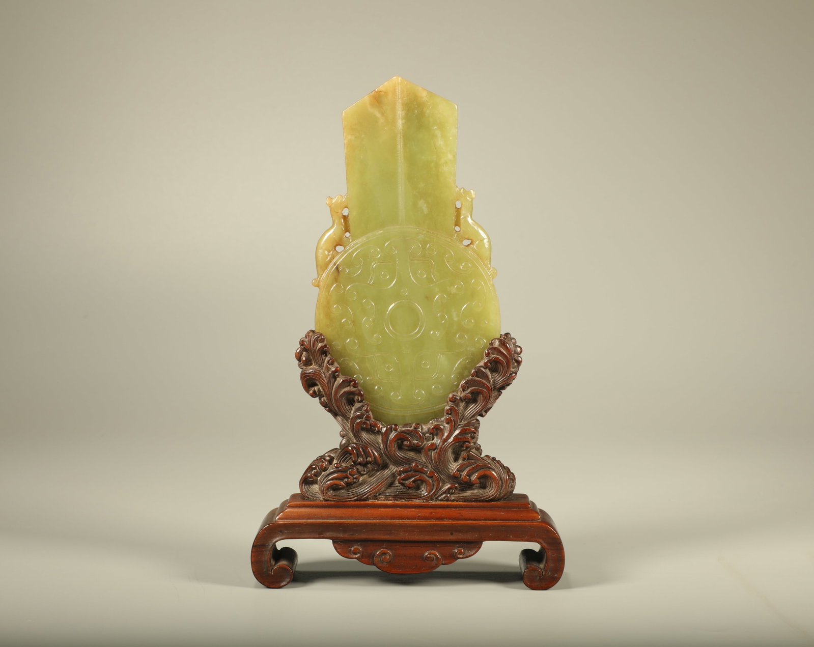 A Chinese Carved Jade Pendant with Hardwood Stand: Ht. 18.5cm