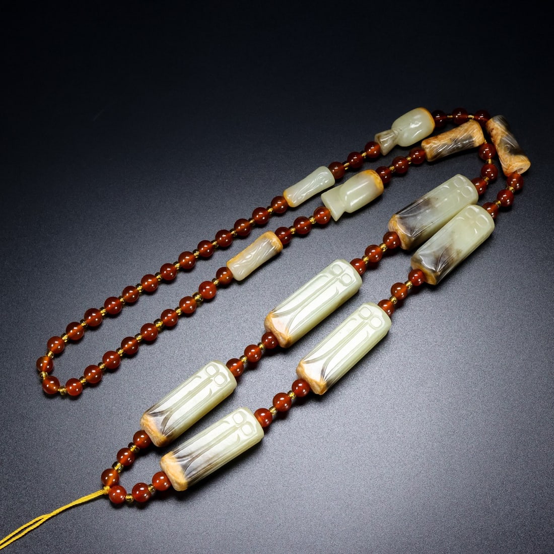 A Chinese Carved Jade Necklace: The Beads, Lg. 1cm, Wd. 1cm, Ht. 4cm, Wt. 115g