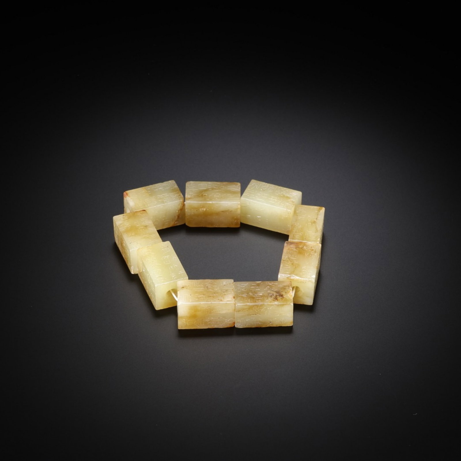 A Chinese Carved Jade Bracelet: The Beads, Lg. 2.1cm, Wd. 1.2cm, Wt. 79g