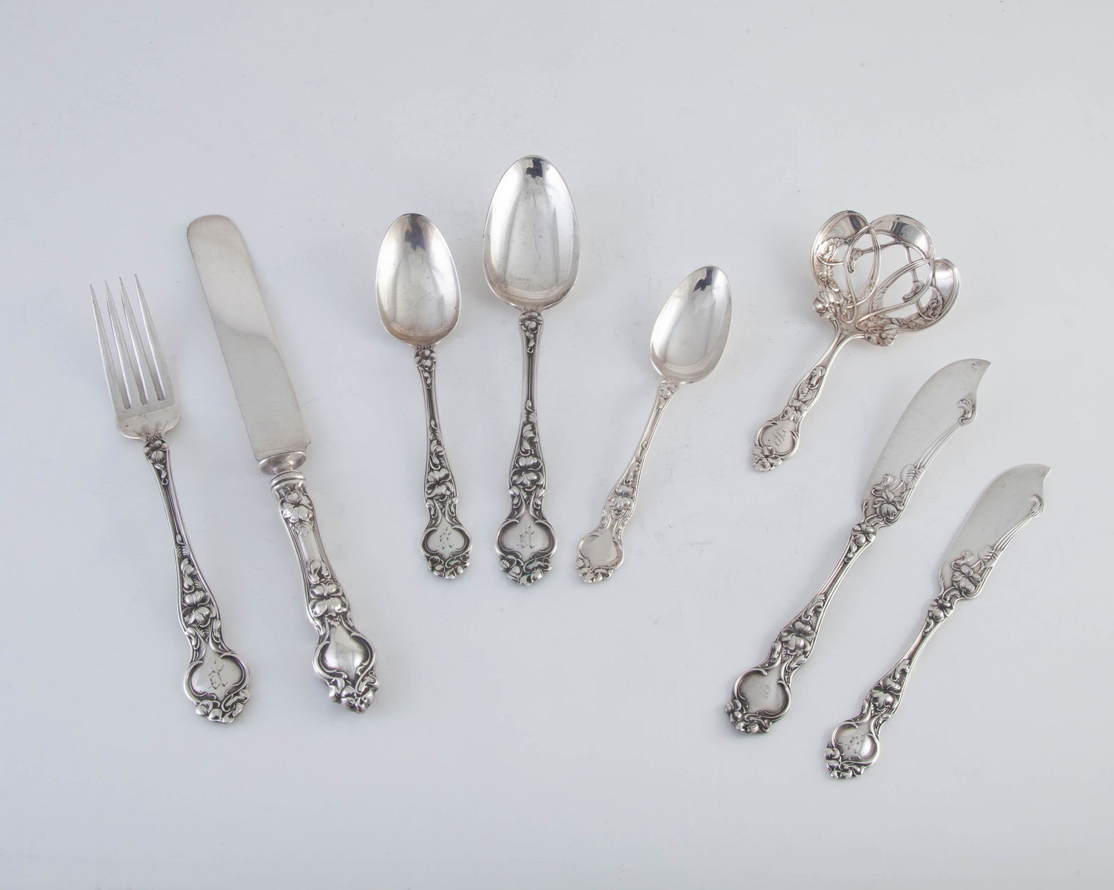 Wallace Silversmiths Violet Sterling Silver Flatware: Set of 50 pieces of flatware in the Violet 1904 pattern, all with monogram P, master butter with monogram D and Bonbon Server with monogram S., in box. 42.08 t.oz. 12 Knives blunt blade 8 ? in12 Forks