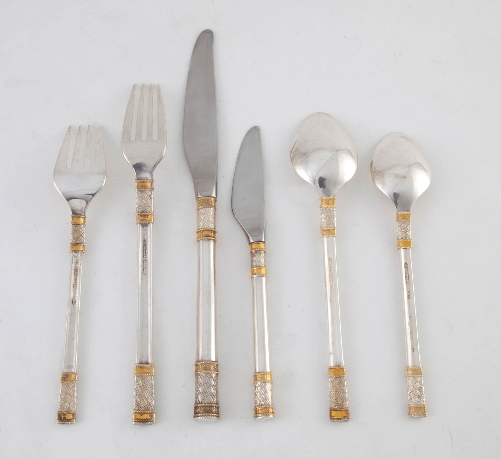 Wallace Silversmiths Gold Aegean Wave Flatware: 48 pieces of flatware vermeil and sterling, circa 1970. 62.89 t.oz. 8 Dinner Forks 8 in8 Dinner Knives 8 ¼ in8 Butter Knives 6 ¾ in8 Salad Forks 6 ¾ in16 tea spoons 6 ½ in