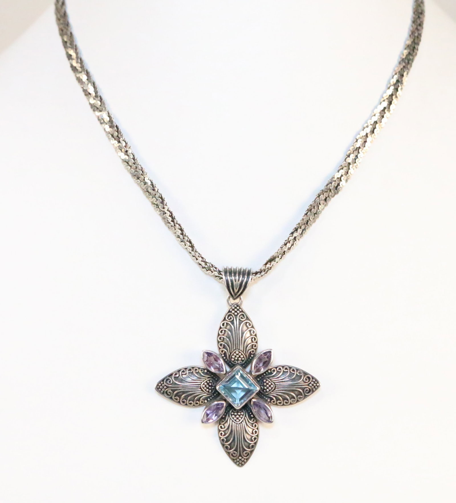 Sterling Silver Amethyst & Topaz Maltese Cross Pendant Necklace: Lovely filigree Cross with Marquise amethyst and emerald cut blue topaz center on a triple braided thick chain. Lovely combination. Chain is 4.9 mm wide. Pendant is 2" x 2". GEMALA 925 INDONESIA. Weig