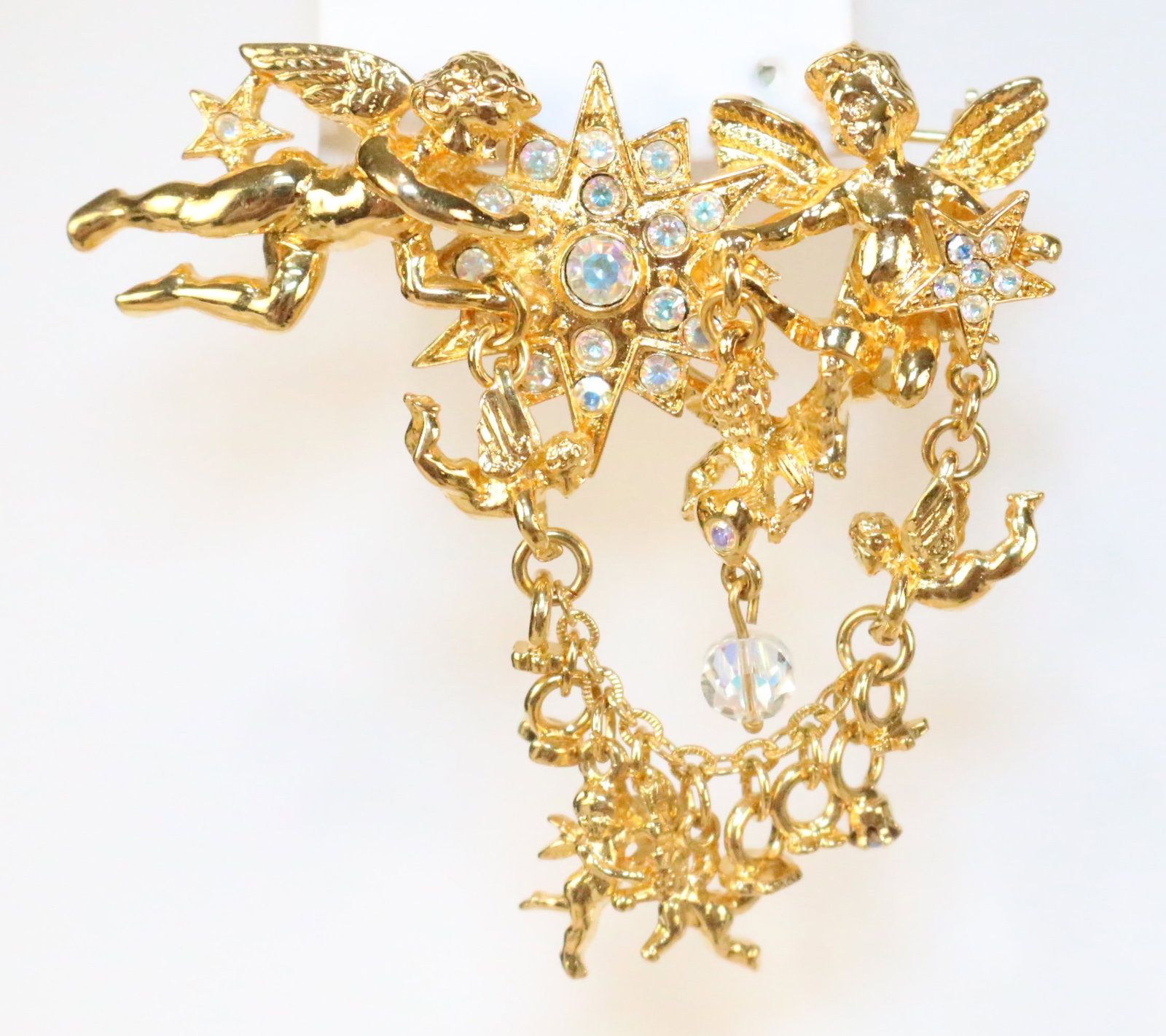 New Kirks Folly Cherub Fairy angels Stars draped Large Brooch: Stamped: Kirks folly. Gold tone and AB crystals. DIMENSIONS: 2-3/4" w x 2-3/4" drop length.