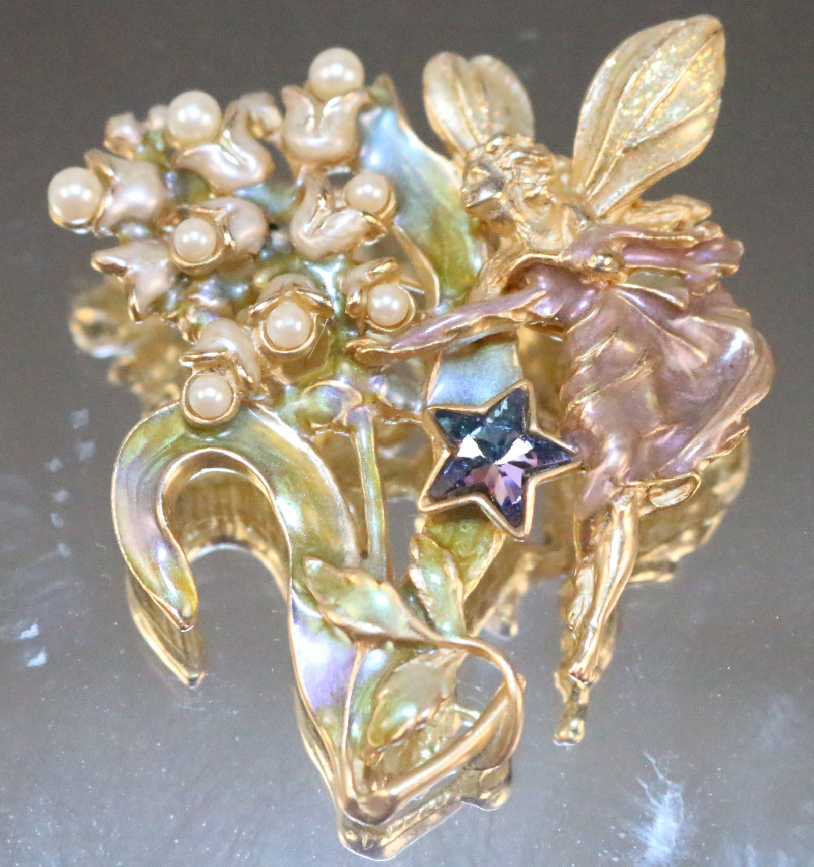 Vintage Kirks Folly Fairy Angel Lilly of the Valley Pearls Crystal Enamel Brooch: Stamped: Kirks Folly. Enamel leaves and dress, Glitter wings, Blue ab star and pearls for the flowers on gold tone. DIMENSIONS: 2-1/2" long x 2-1/4" wide.