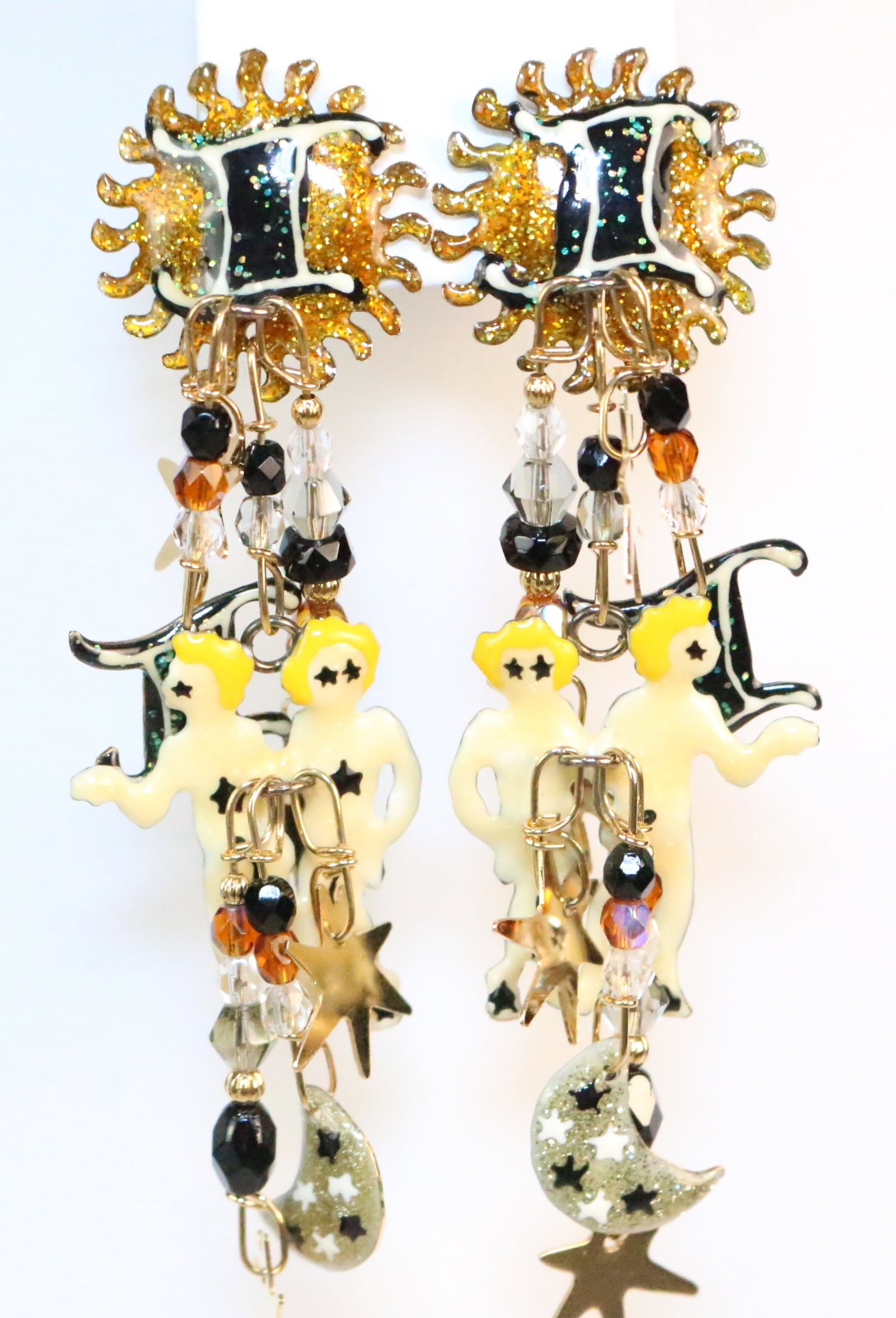 Lunch at the Ritz 24kt GP Enamel Crystal Zodiac Gemini Pierced Earrings: Stamped: Lunch at the Ritz. Made in the USA. Enamel with Crystals. Gemini Sign, stars moon, Twin people all with crystal long dangle earrings. DIMENSIONS: 4" Drop