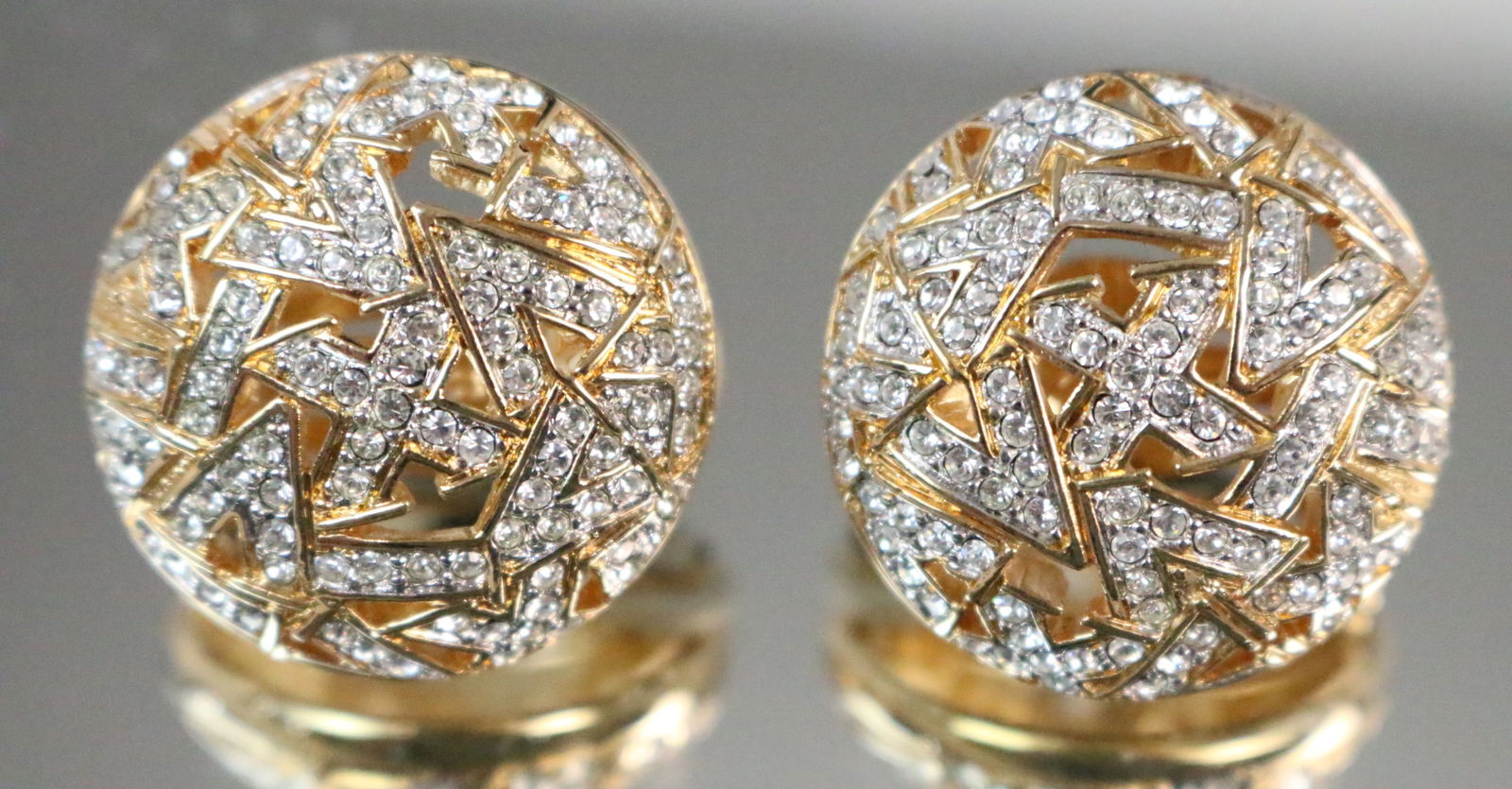 New Vintage Old Stock Swarovski Crystal Jewelers Collection 18kt gold plate Clip Earrings Round: Stamped: Swarovski Swan Logo. Brushed Gold with a modernist crystal geometric design round dome earrings clip backs. Loads of Swarovski sparkly crystals. BRAND NEW RARE OLD STOCK Jewelry Swarovski Jew