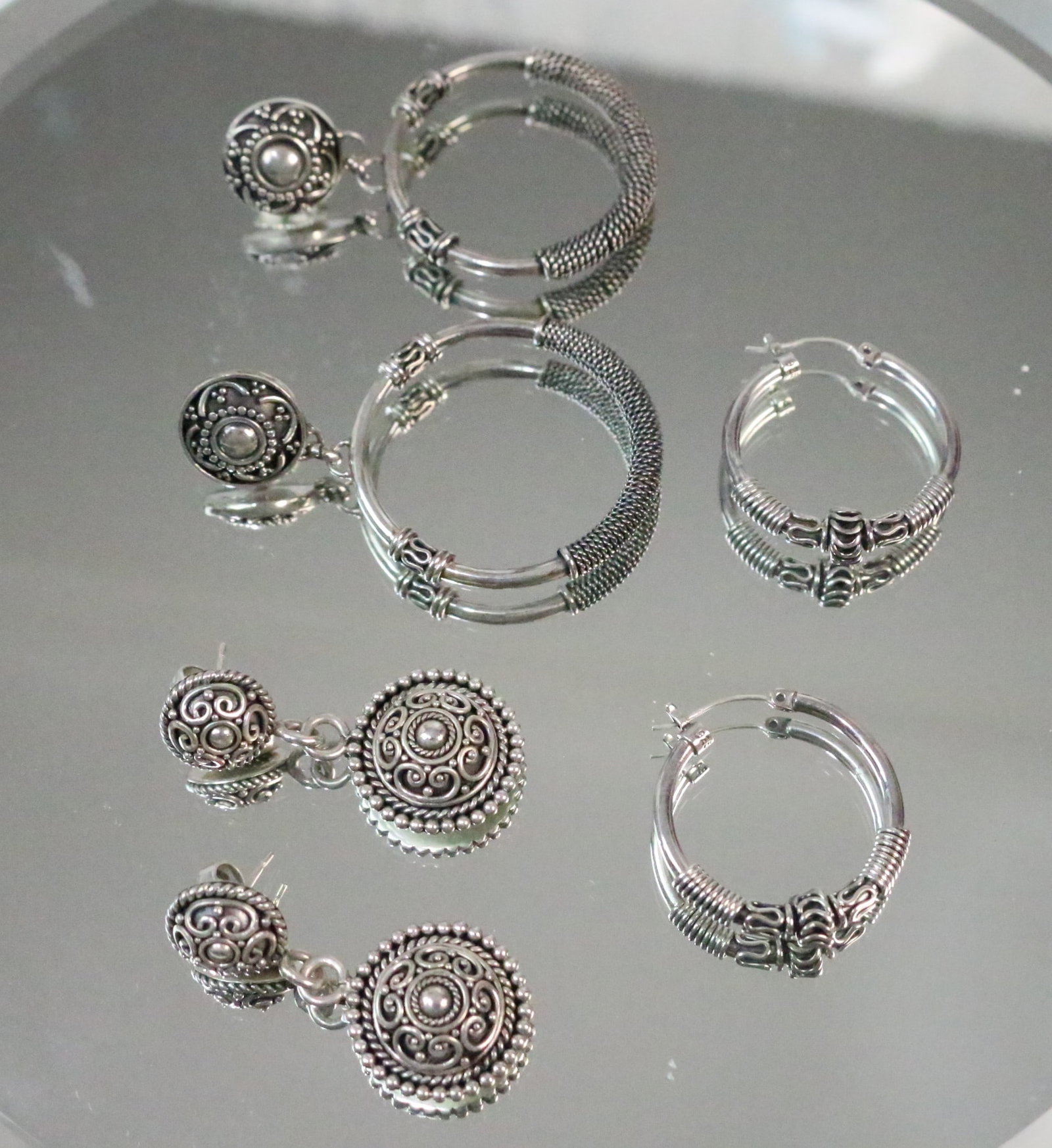 Sterling Silver Lot of 3 pair of Suarti Bali BA Earrings Pierced: Stamped: BA 925 on each pair. Made in Indonesia. Beautiful designed swirl, beading . All pierced. DIMENSIONS: Total weight of 3 pair 35.1 grams. Hoops are 1" diameter. Drop hoops are 1-3/4" hoops with