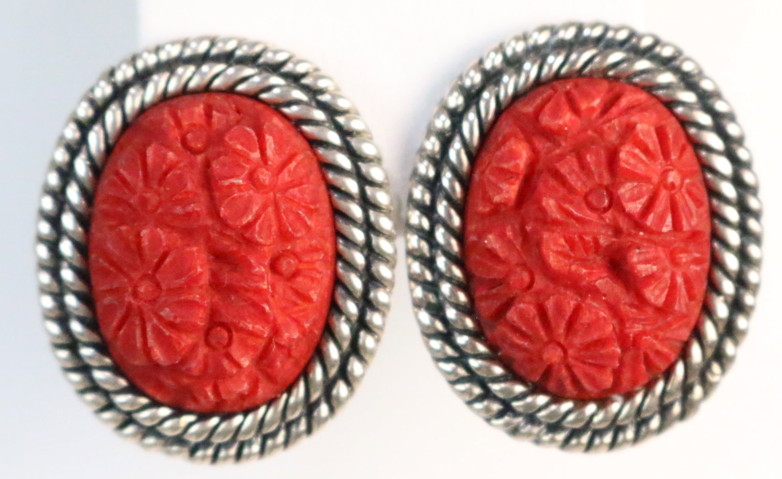 Sterling Silver AKR Amy Kahn Russell Carved Carnelian Pierced Earrings: Stamped: AKR 925 China. Large oval carved carnelian Daisies flowers with double rope sterling setting. Omega back pierced earrings. Coordinates with lots 124 & 125. DIMENSIONS: Approx 1-1/4" l x 1" w.