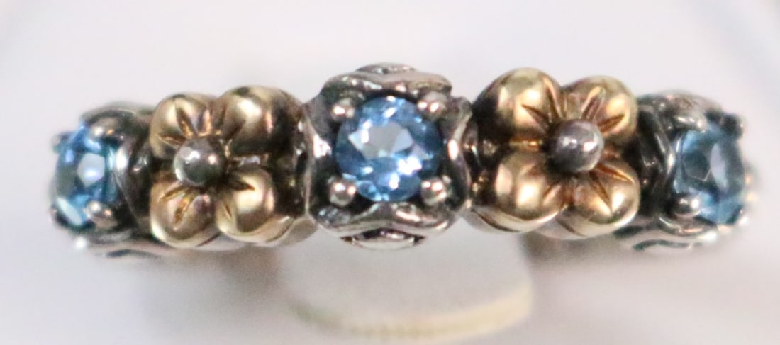 Barbara Bixby Sterling Silver 18kt Gold Blue topaz lotus flower ring: Stamped: Bixby 925 18kt. 18kt gold lotus flowers with white topaz accents in the center and 3 blue topaz stones. DIMENSIONS: Size 6.75. Just shy of 1/4" wide.