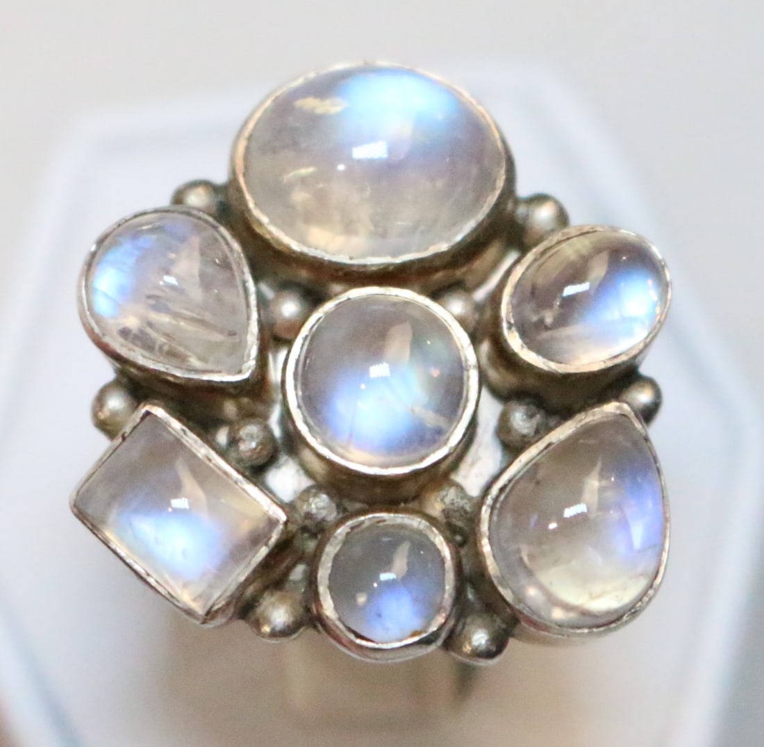 SJ Sterling Silver Moonstone Ring: STAMPED: SJ 925. DETAILS: Gorgeous solid sterling silver setting with raised dots in-between the moonstones settings. Features 7 beautiful moonstones in various shapes and sizes. DIMENSION: ring size