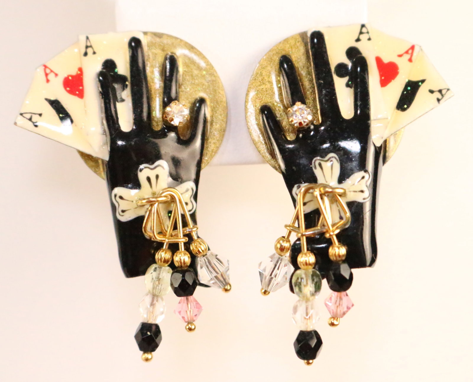 Lunch At the Ritz USA 24kt Gold Plated Antipasto Card Game Earrings: STAMPED: Lunch at The Ritz. DETAILS: Clip Earrings feature Black Glove hands with crystals and a "diamond look" Crystal ring on each gloved hand holding 3 Aces in each hand.