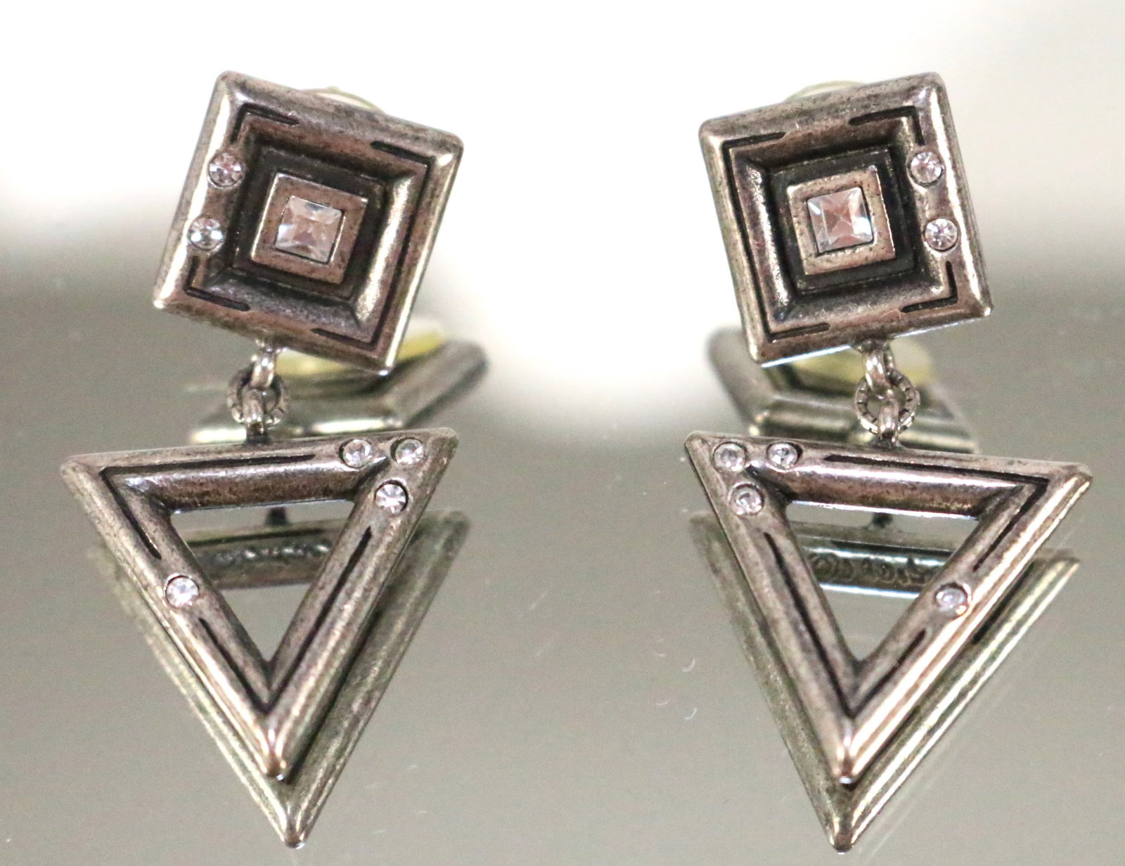 Patricia Locke USA MADE Silver tone Modernist Geometric Pierced Earrings: SIGNED: P. LOCKE . DETAILS: Square and triangle modern design silver tone blackened accents with clear crystal accents. SIZE/DIMENSIONS: 1.5" long. X approx. 1" wide. WEIGHT: 17.3 grams.