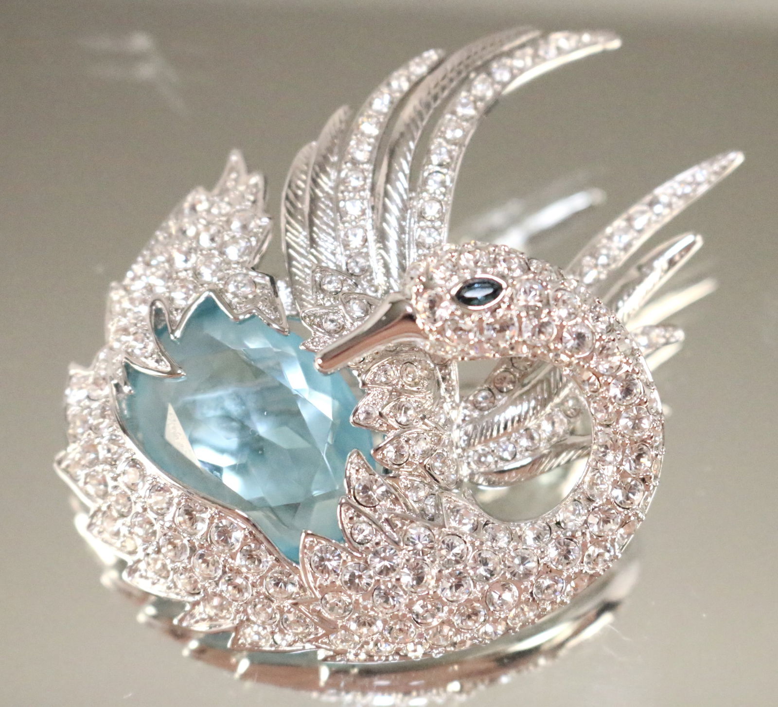 Nolan Miller NEW Large Crystal Silver tone Blue Swan Brooch.: SIGNED: NOLAN MILLER. DETAILS: Big beautiful brilliant crystals and a large blue clear stone belly and eye. NEW. No box. SIZE/DIMENSIONS: 2.5" x 2.25"