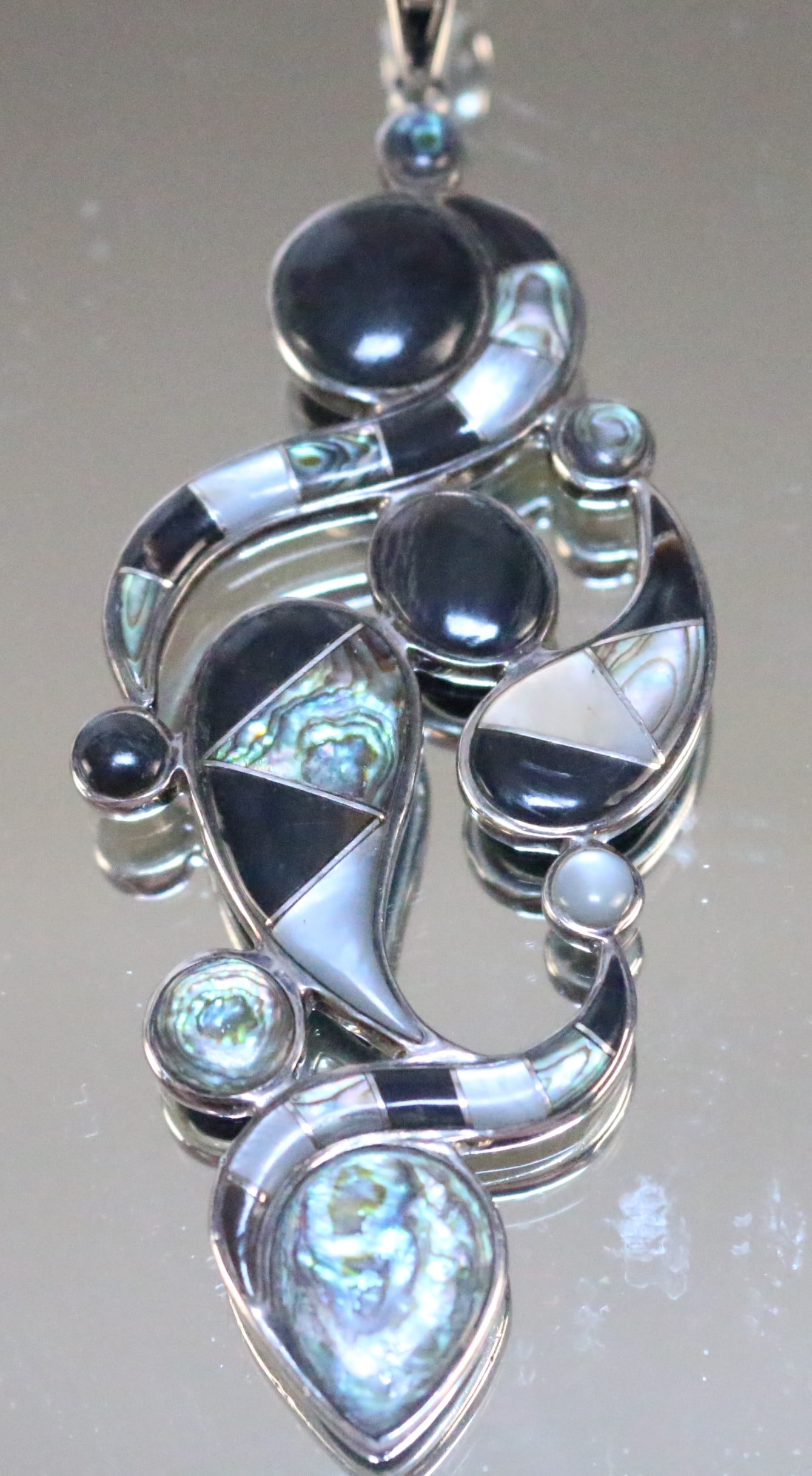 Sajen Sterling Silver LONG Onyx abalone, MOP Pendant: SIGNED: SAJEN 925. DETAILS: HUGE Beautiful pendant with modern geometric design in various shapes of Black onyx, moonstone, abalone, & mother of pearl. SIZE/DIMENSIONS: Pendant wit 4.25" LONG! With th