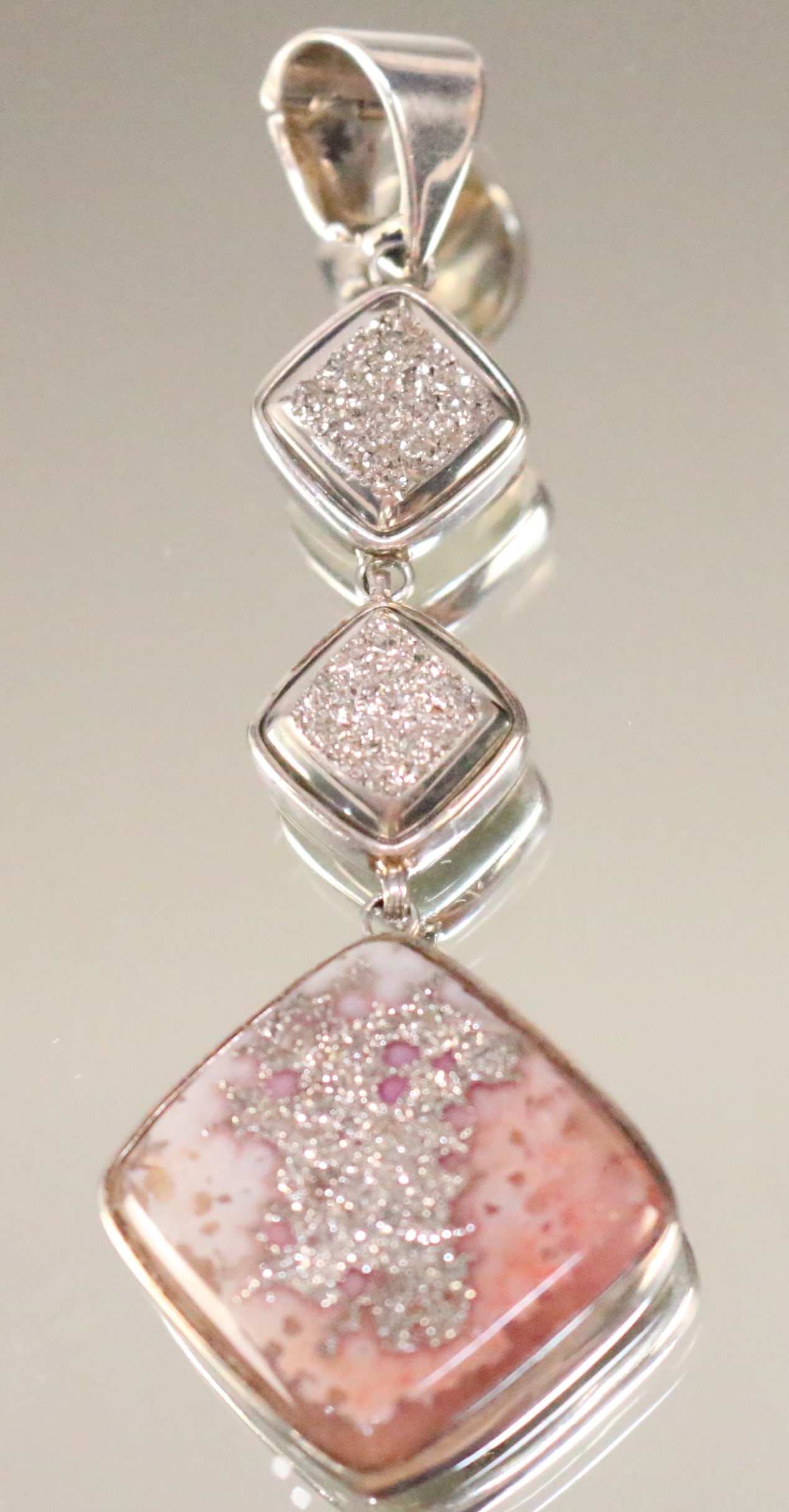 Stephen Dweck 2011 ONE OF A KIND Pink Druzy Pendant: SIGNED: Stephen Dweck One of a Kind 2011 Embossed Adam Beetle. STERLING . Serial number 31270 DETAILS: STUNNING 3 diamond shaped large Pink Druzy stones. Largest SIZE/DIMENSIONS: Total length 2.25" x