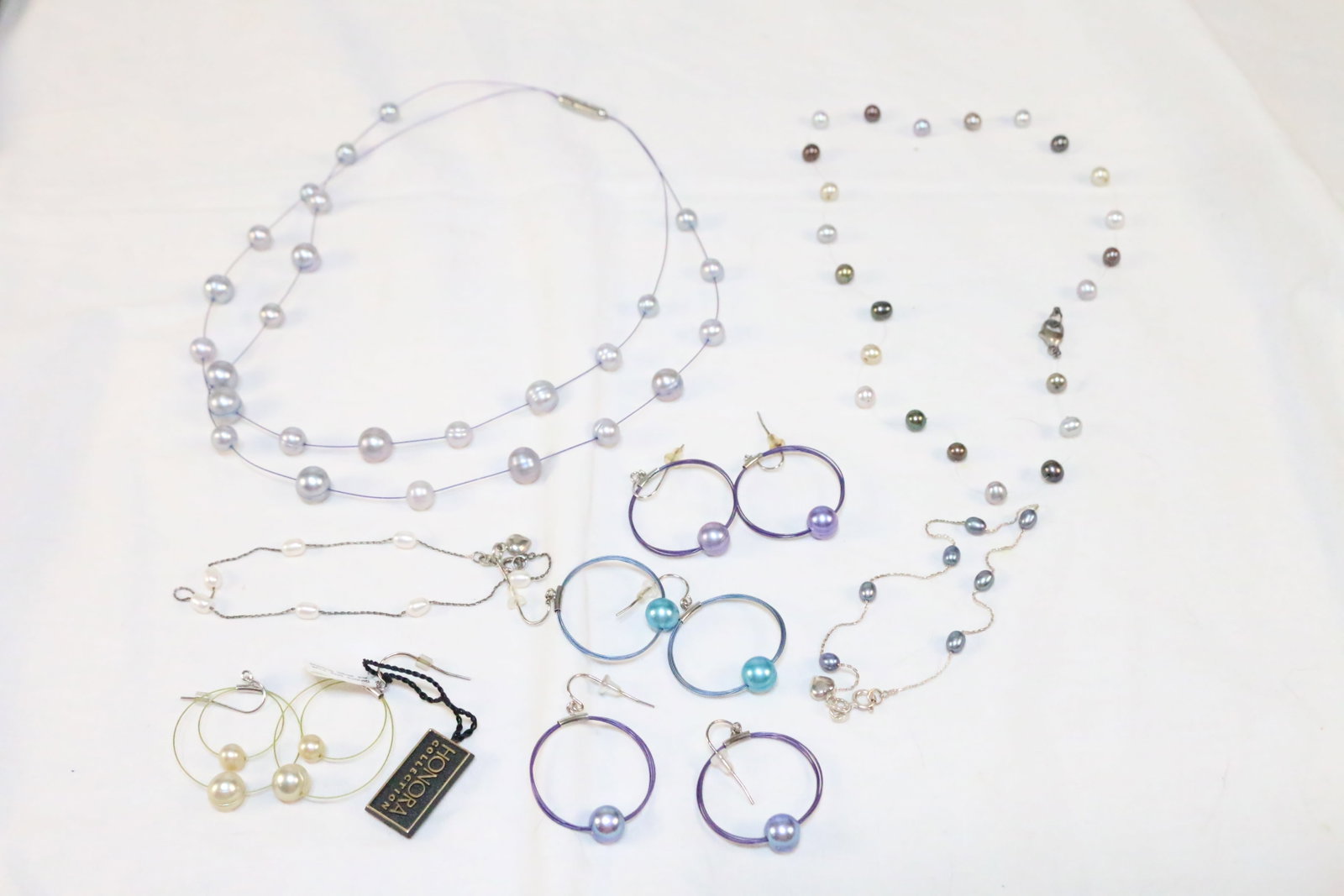 Lot of 7 Honora Freshwater Pearl NEW & Estate Earrings, Necklaces and Bracelets Sterling Silver: SIGNED: H. 925 & one stainless. DETAILS: 2 sterling silver 9" oval freshwater pearl bracelets with sterling heart charms. 1 station necklace 18" long on wire with sterling clasp. 1 large silver gray r