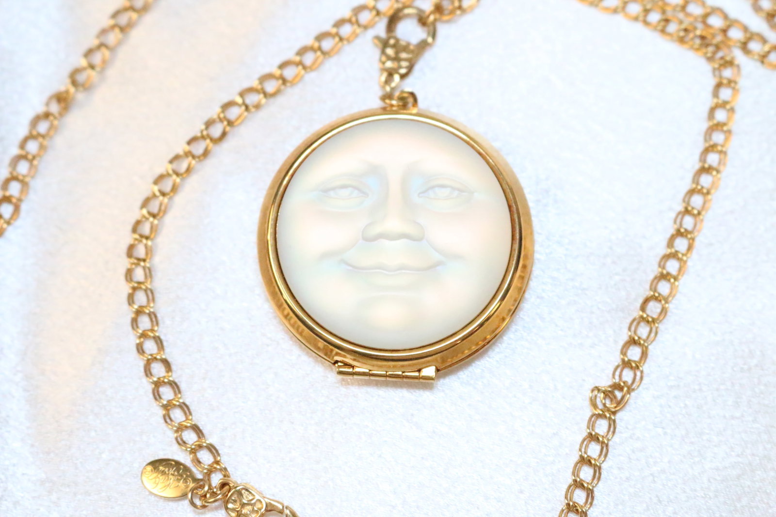 Kirks Folly Seaview Moon Etched Large Locket Necklace: DESCRIPTION: Signed Kirks Folly. Etched SEAVIEW MOON on the back of the locket. Domed locket opens to reveal and angel on a moon boat on a cloud. Has 2 lobster clasps DIMENSIONS: Locket is 1-5/8" diam