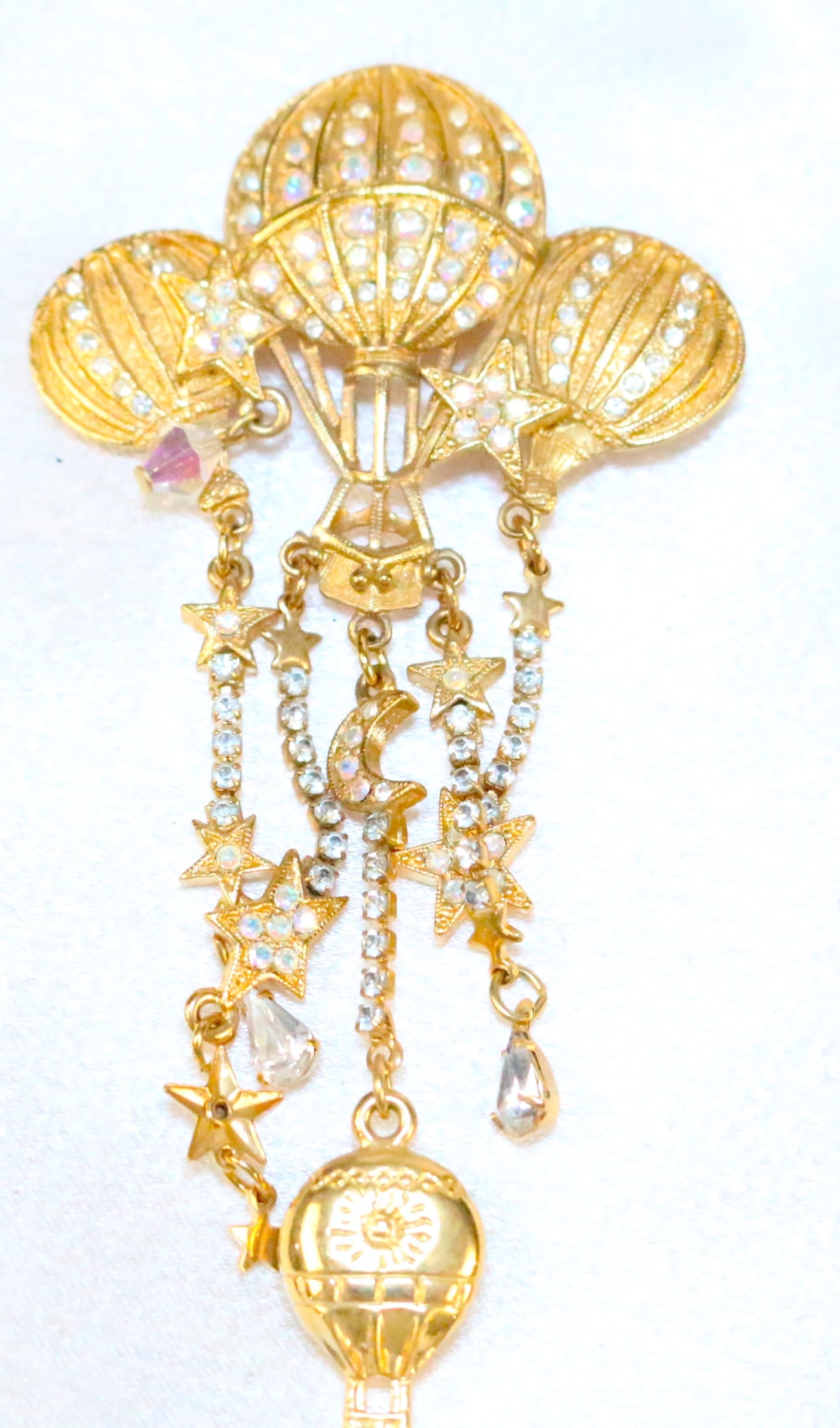 Kirks Folly Gold tone Hot Air Balloons Compass Brooch: DESCRIPTION: Signed Kirks Folly. Brushed gold tone, starts, balloons, crystals and working compass. DIMENSIONS: 2" w x 4" long to the end of the compass.