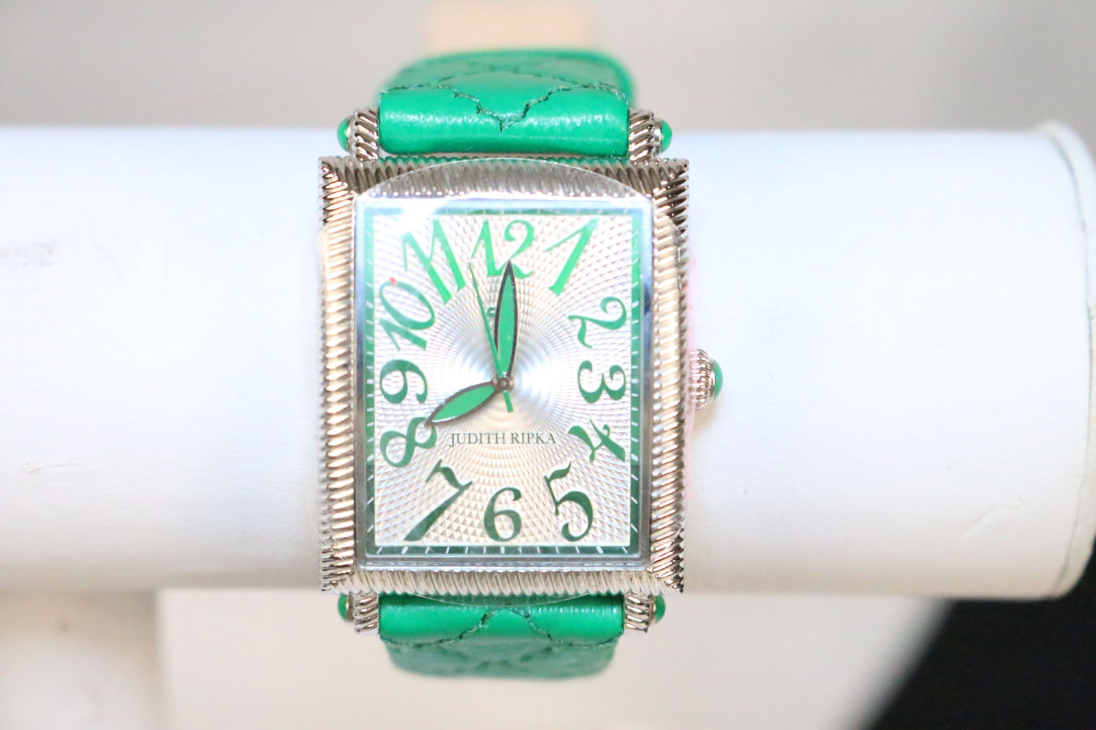 Nearly New Vintage Judith Ripka Bright Green Leather Watch in the Box: DESCRIPTION: Looks new. Protective cover on face and back. Wide quilted bright green leather with green gemstones. Green numbers. Stainless. Not tested. May need a battery. DIMENSIONS: