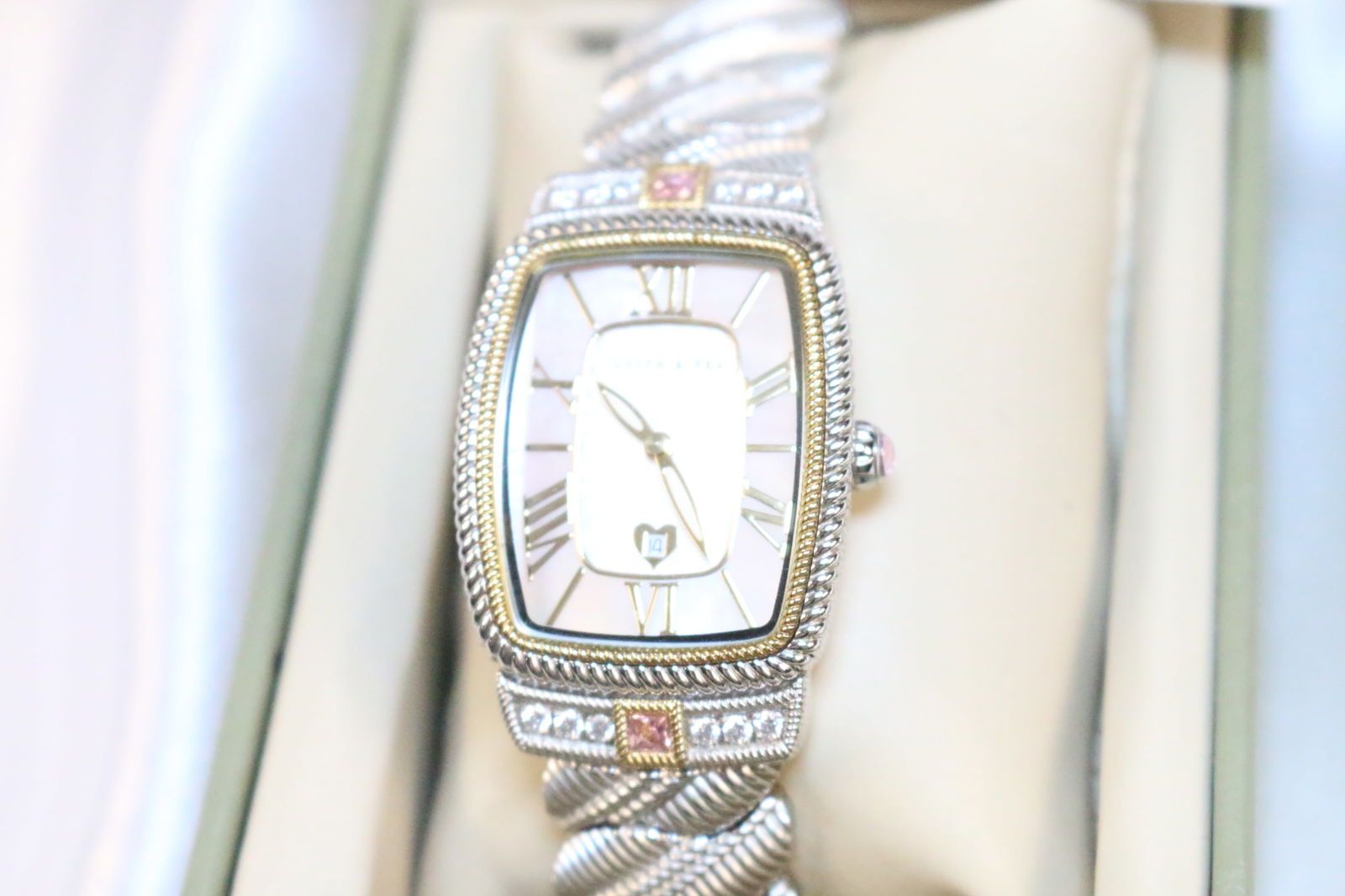 Judith Ripka Wide Stainless MOP tri color Watch in the Box: DESCRIPTION: Protective plastic cover on back and face. Pink and clear Diamonique, gold tone, rose gold borders. Wide band. MOP face. Excellent condition. Not tested. Comes with papers. May need a bat