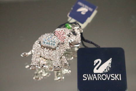 NEW with tag Swarovski Elephant Crystal Brooch: NEW Old stock with tag $125.00. Upturned trunk. Pink blue and clear crystals. Swarovski swan logo