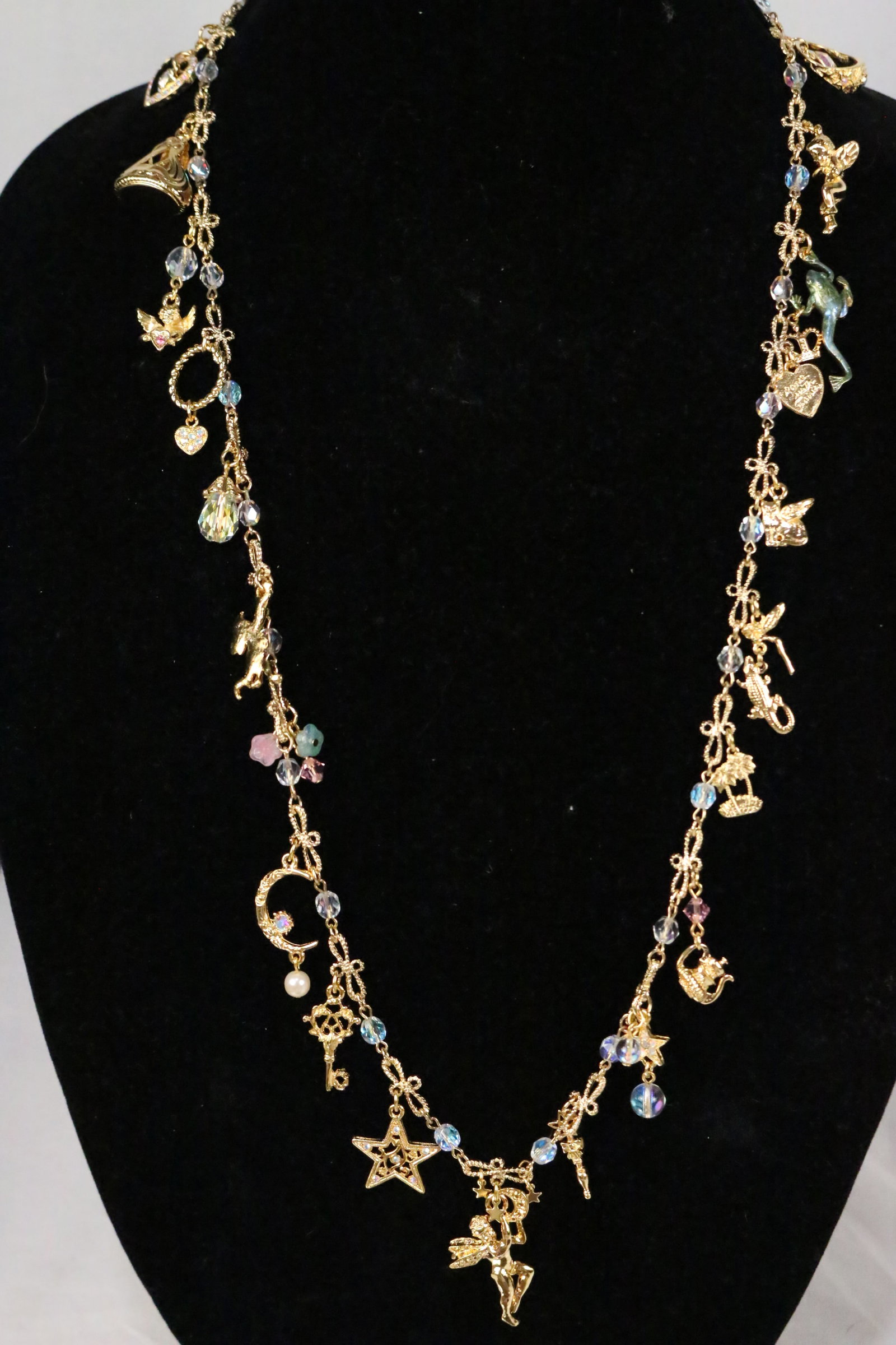 NEW RARE Kirks Folly Textured Charm Necklace In box 32": BRAND NEW IN THE PINK KIRKS FOLLY BOX. Features: Dance with fairies, frog, rings, heart, stars, cherubs, crescent moon, alligator, palm trees, teapots and much more on a RARE gorgeous rope twist infin