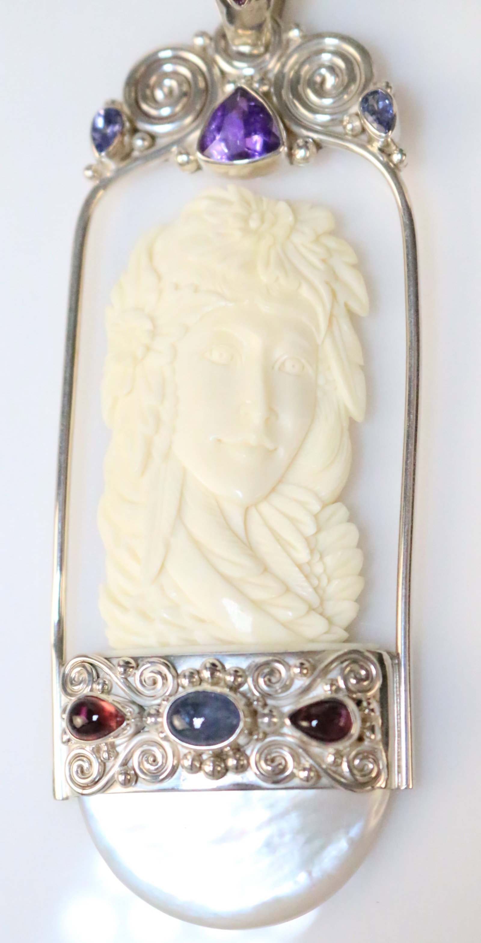 RARE SAJEN Sterling silver HUGE Ivory color bone carved GODDESS multi gemstone pendant: Features a HUGE Ivory Goddess with flowers in her hair, Mother of pearl large half moon base, multi gemstones in Amethyst, Tanzanite, tourmaline. Measures: 3-1/8" long x 1-3/8" wide. Gemstones are 6-9