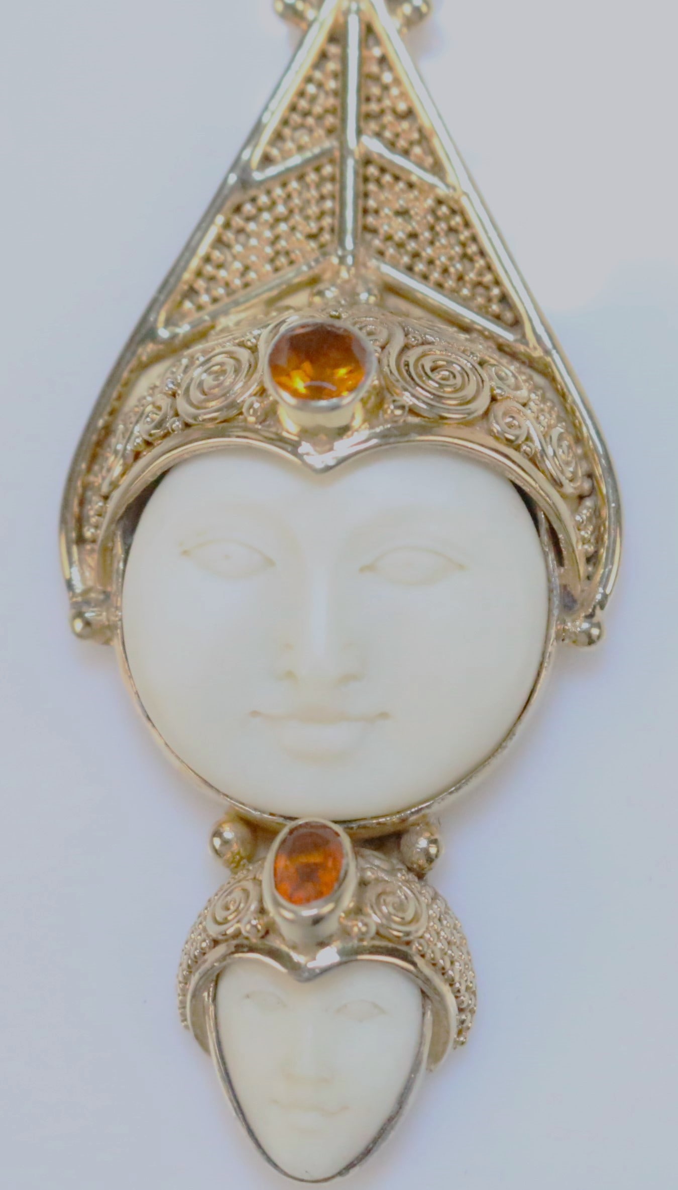 RARE SAJEN Two Ivory color bone carved Goddess Face Gold over Sterling silver gemstone large Pendant: VERY HARD TO FIND Sajen in gold over hefty solid sterling silver setting. Brilliant gold. No tarnish. Round goddess moon style face and teardrop goddess face. Each has an orange citrine gemstone and t