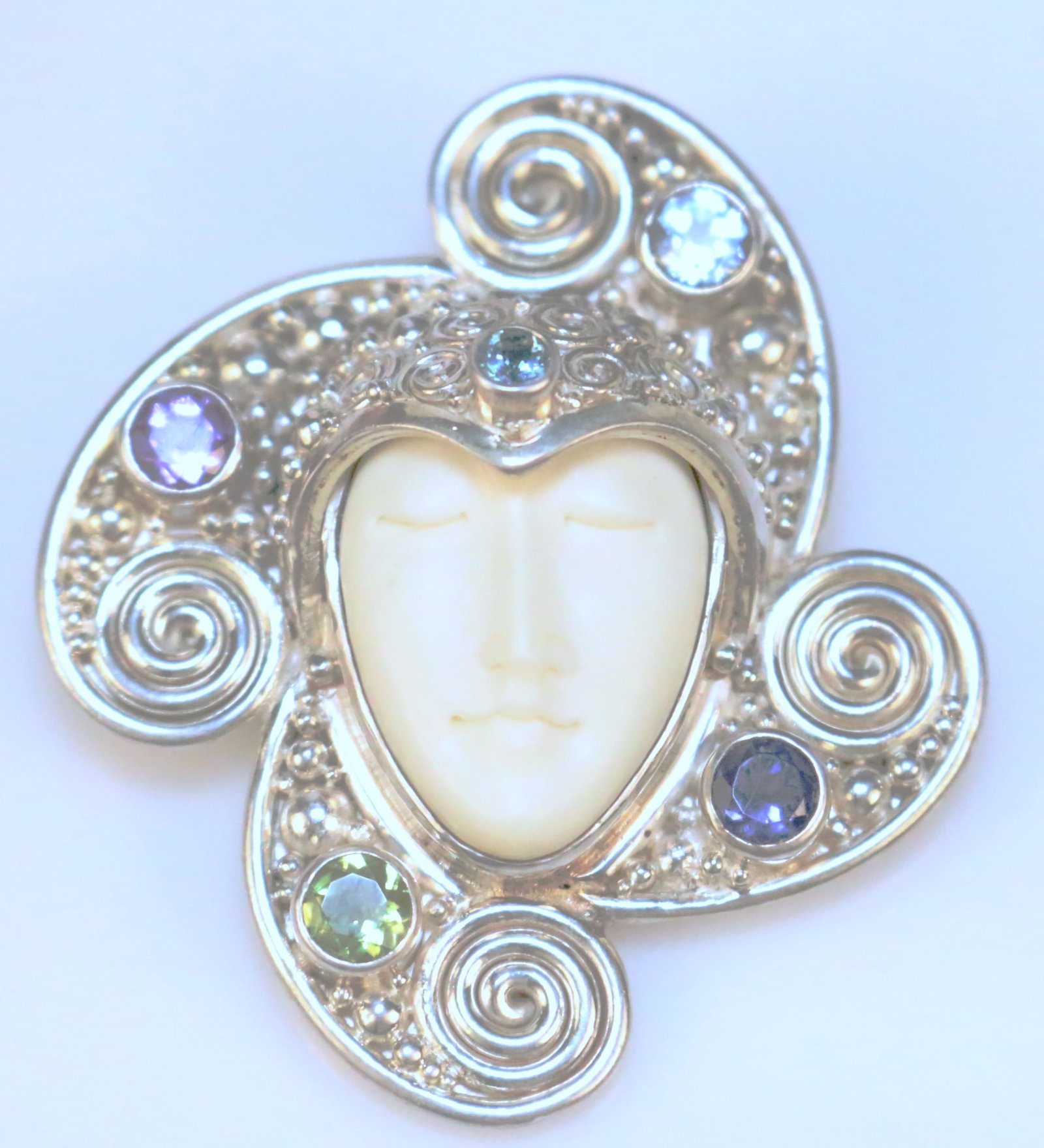 RARE SAJEN Ivory Colored Bone Carved Goddess Gemstone Sterling silver Brooch Pendant: GORGEOUS Huge Ornated Sterling silver setting with multicolor gemstones in amethyst, tanzanite, aquamarine, blue topaz and chrysoprase colors. Carved ivory colored goddess. Measures: 2" l x over 1-3/4