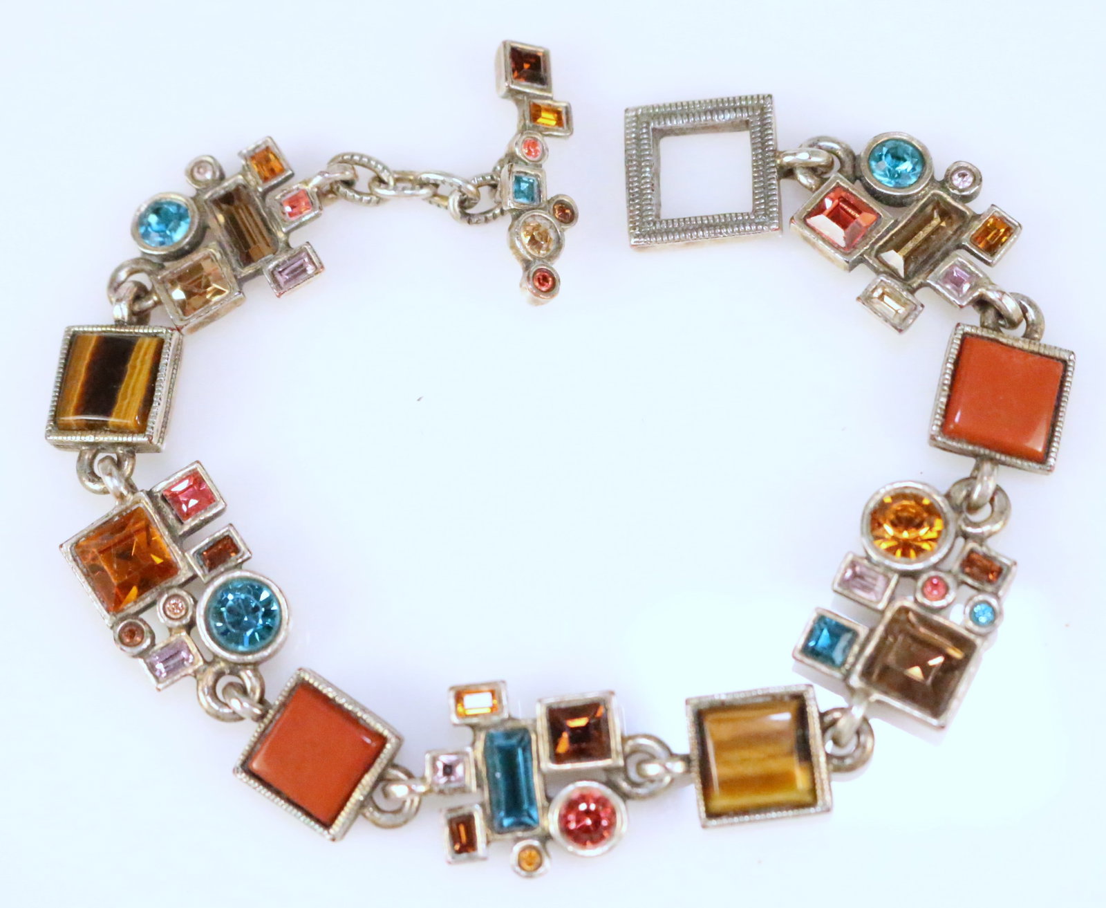 Patricia Locke USA Jewelry Designer Multicolor geometric modernist Toggle bracelet: Genuine stones in carnelian, tiger eye, topaz multi gemstone toggle bracelet. .Measures: 7.25" brushed gold tone finish. HALLMARKED P. LOCKE 05' USA Collectors items - Patricia Locke is retiring May 2