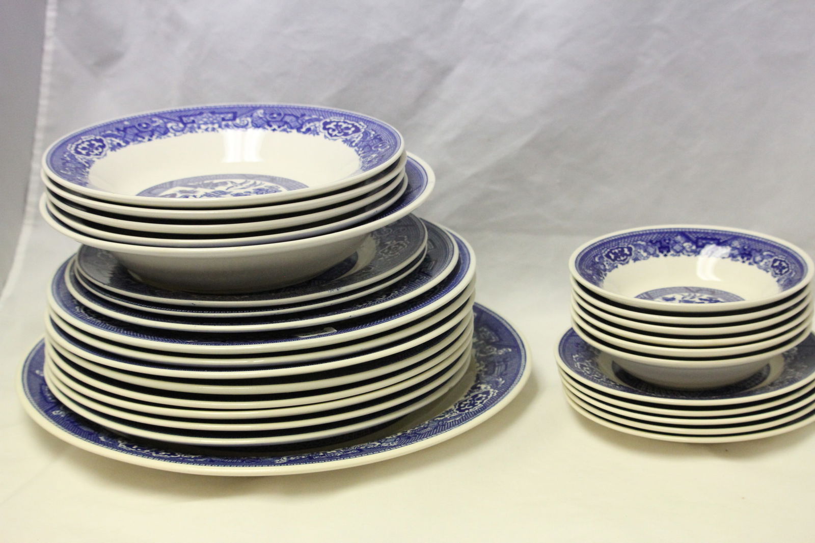 Vintage Blue Willow By Royal China Lot of 28 most marked Willow Ware by Royal China: Approx. 6"-13"varying sizes. 1 large serving platter. 1 serving bowl. 11 plates. 4 bowls. 6 small bowls. 5 small plates. All marked with logo on bottom.