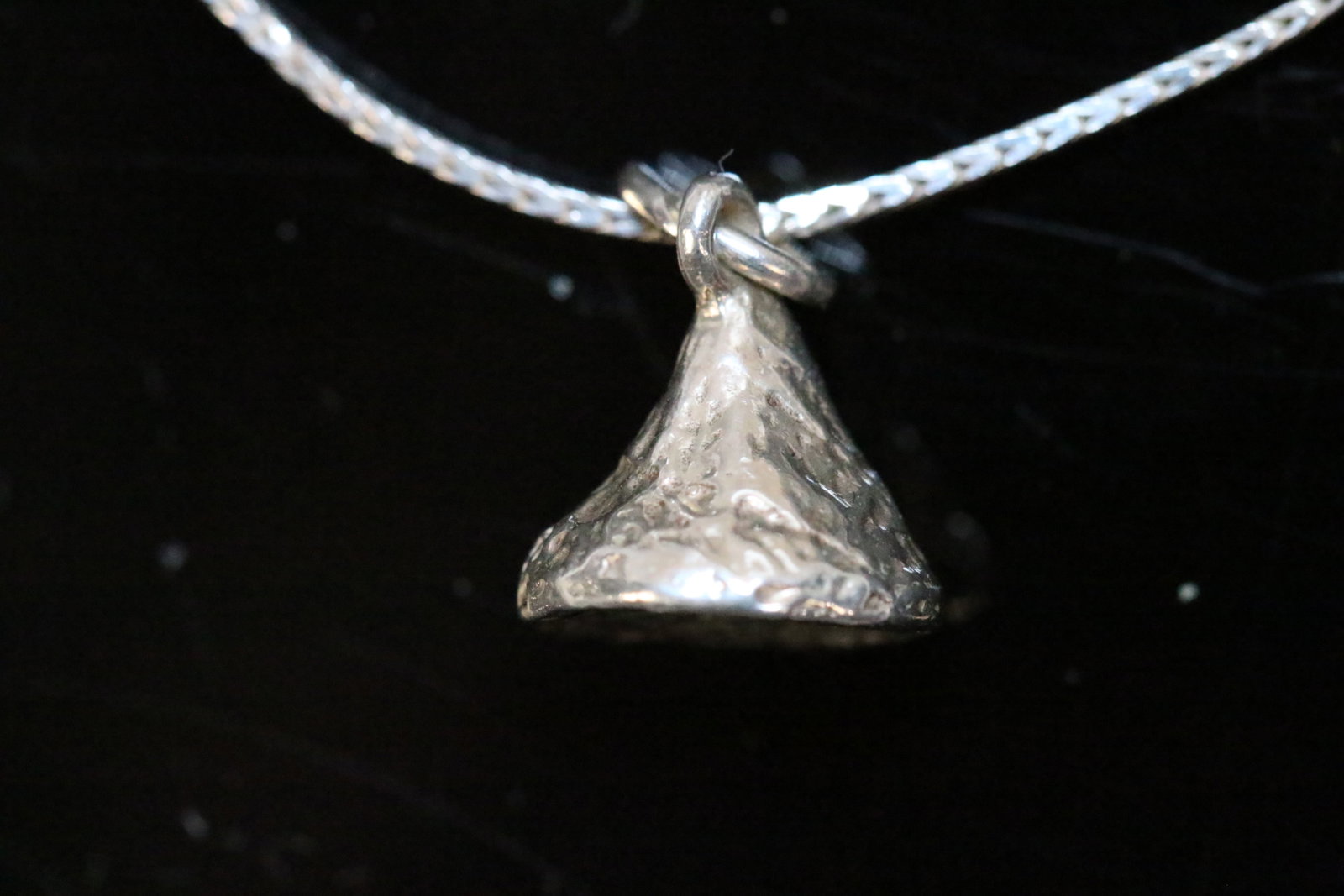 Sterling Silver Hershey Kiss Pendant Necklace: Give her a kiss, a Hershey kiss for Valentines day! This adorable sterling silver Hershey kiss charm is on a sterling silver 30" chain stamped 925 Italy. Hershey kiss pendant charm is approx. 1/2" x 1